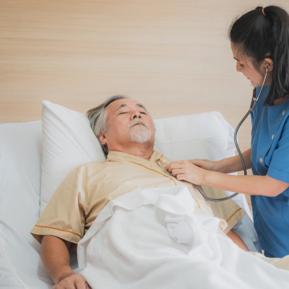 nursing home care concept the healthy nurse helping support and checking the elderly male